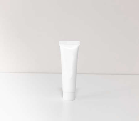 Beautiful tubes on a beautiful white table. No labels. For cosmetics.の写真素材