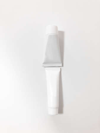 Beautiful tubes on a beautiful white table. No labels. For cosmetics.の写真素材