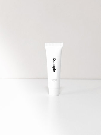 Beautiful tubes on a beautiful white table. No labels. For cosmetics.の写真素材