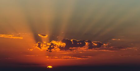 Sun rays between cloudsの写真素材