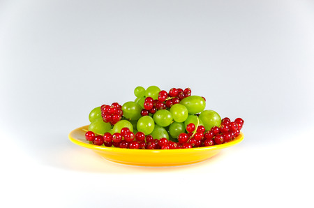 Plate of fruits on white tableの写真素材