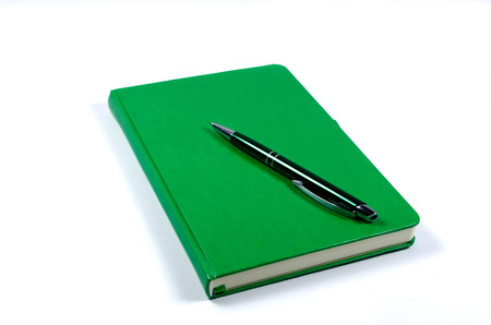 Green notebook isolated on whiteの写真素材