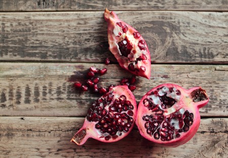 Fresh granate fruit on old wooden tableの写真素材