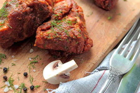 Pork ribs with mushrooms, garlic and fresh herbsの写真素材