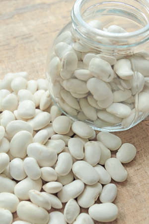 Uncooked white beans in a glass jar