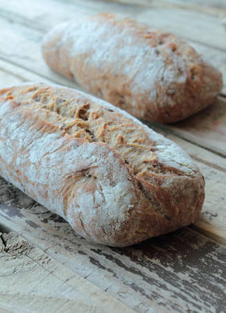 Wheat healthy bread rolls on a wooden table