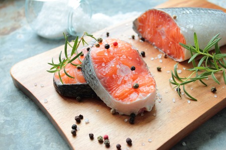 Fresh salmon filets on wooden cutting boardの写真素材