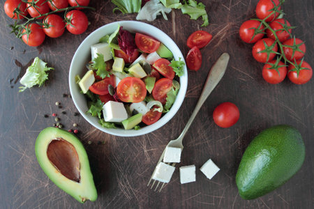 Vegetable salad with fresh tomatoes, lettuce, avocado and feta cheeseの写真素材