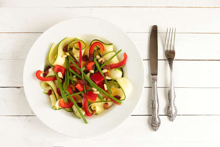 Salad with zucchini, paprika, chive and dried fruitsの写真素材