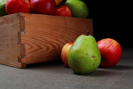 Juicy pears and apples. Autumn fruits in a wooden box.の写真素材