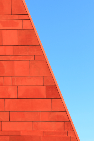 Architecture abstract. Red brick wall over blue sky