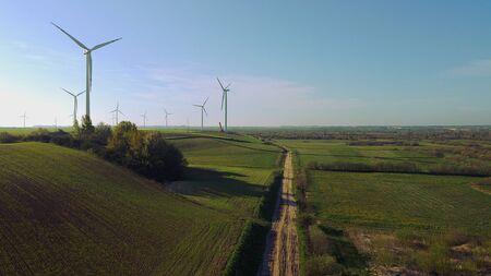 Wind farm towers surrounded by agricultural fields in Polish country side. Pomerania, Poland.