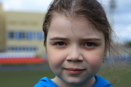 Girl performs gymnastic exercises in an outdoor stadiumの写真素材