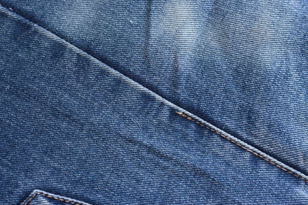 a few old denim pants lying nearbyの写真素材