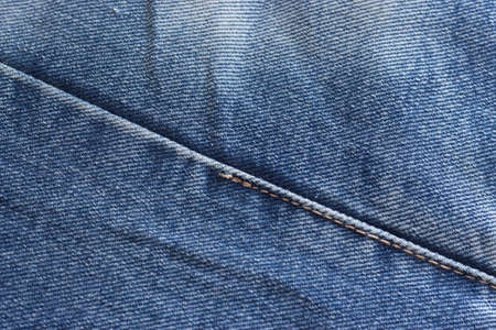 a few old denim pants lying nearbyの写真素材