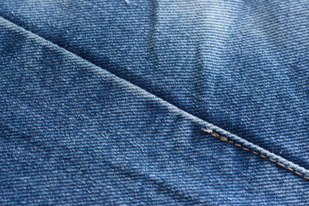 a few old denim pants lying nearbyの写真素材