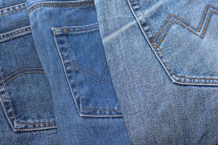 a few old denim pants lying nearby