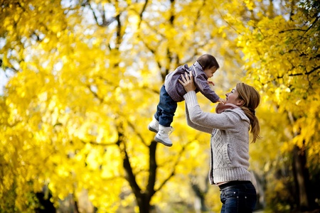 Mother and baby girl in the autumn forest Mother and baby girl in the autumn forest