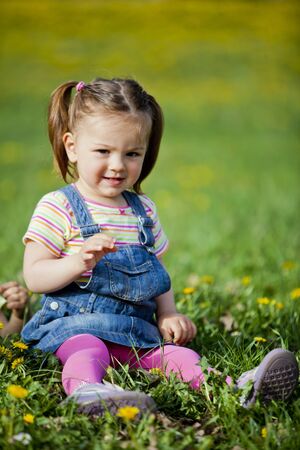 Little girl in the spring fieldの写真素材