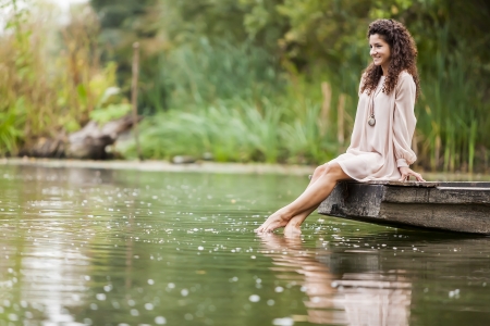 Young woman on the calm lakeの写真素材