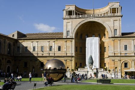 People around Sphere within sphere in Courtyard of the Pinecone at Vatican Museums at October 14, 2011. Sphere was created in 1990 by Italian sculptor Arnoldo Pomodoro.のeditorial素材