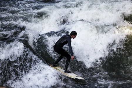 Munich, Germany, October 23, 2011 - Unidentified surfer in the Eisbach river in English Garden in Munich, Germany. The first surfers discovered the Eisbach in the 1970's.のeditorial素材