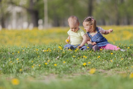 Two kids in the spring fieldの写真素材