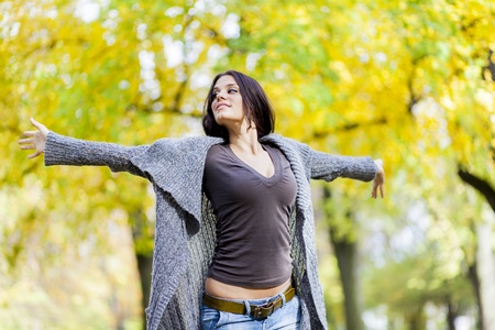Young woman in the autumn forestの写真素材