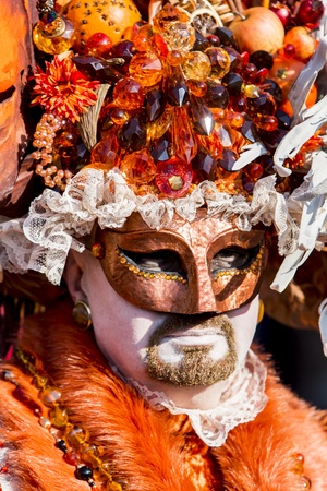 Venice, Italy, February 9, 2013: Unidentified person with traditional Venetian carnival mask in Venice, Italy at February 10, 2013. At 2013 it is held from January 26th to February 12th.のeditorial素材