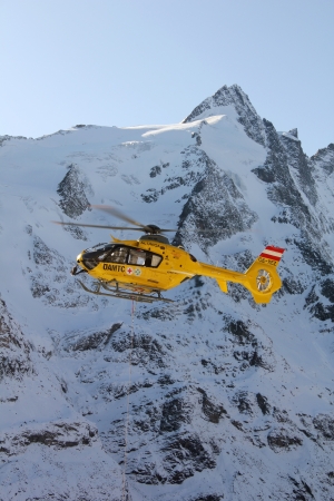 Grossglockner, Austria, October 30, 2011 - Rescue helicopter from Austrian Mountain Rescue Service flying at accident site. At 2001 Rescue Service performed a total of 6508 rescues.のeditorial素材