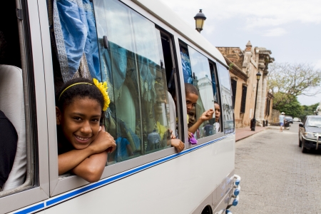Santo Domingo, Dominican Republic - April 24, 2013: Unidentified girl at the bus on thestreet of Santo Domingo. Population of Santo Domingo at 2002was estimated at 2,987,013 people.のeditorial素材