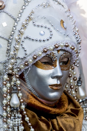 Venice, Italy, February 9, 2013: Unidentified person with traditional Venetian carnival mask in Venice, Italy at February 10, 2013. At 2013 it is held from January 26th to February 12th.のeditorial素材