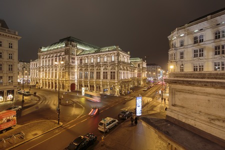 VIENNA, AUSTRIA - FEBRUARY 5, 2014: Unidentified people in front of Vienna State Opera at night. Vienna State Opera was completed in 1869 in the Neo-Renaissance style.のeditorial素材