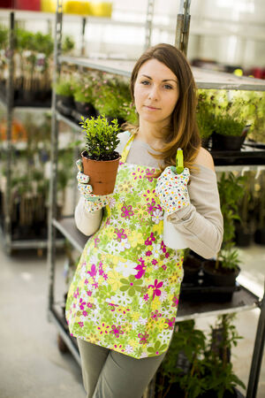 Young woman in flower gardenの写真素材