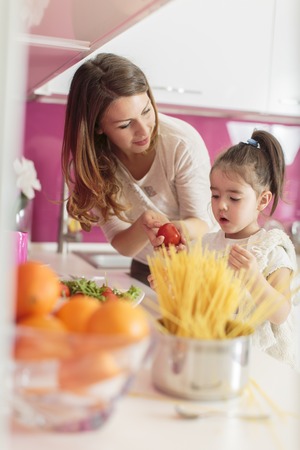 Mother and daughter in the kitchenの写真素材