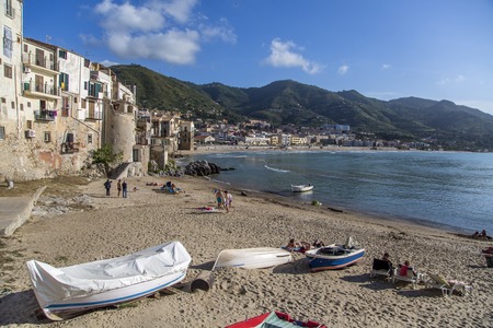 CEFALU, ITALY - APRIL 30, 2014: CEFALU, ITALY - AUGUST 23: Unidentified people at beach in Cefalu, Sicily, Italy. Cefalu is an attractive historic town and seaside resort.のeditorial素材