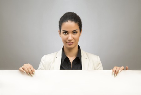 Young business woman with blank white boardの写真素材