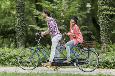 Young couple riding on the bicycleの写真素材