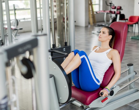 Pretty young woman training in the gym