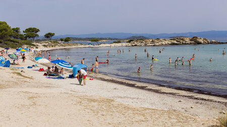 VOURVOUROU, GREECE - JUNE 25, 2014: Unidentified people on the Karidi beach at Vourvourou, Greece. Karidi beach is one of most attractive beaches at Sithonia, peninsula located on central part of Chalkidiki.のeditorial素材