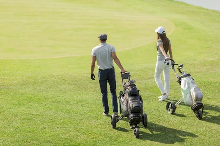 Young couple playing golfの写真素材