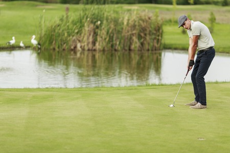 Young man playing golfのeditorial素材