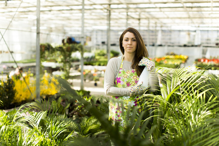 Young woman in flower gardenの写真素材