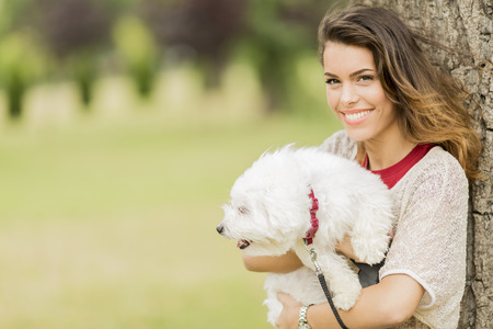 Young woman with a maltese dogの写真素材