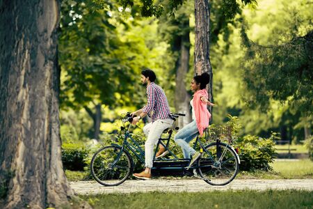 Young couple riding on the bicycleの写真素材