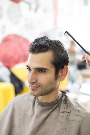 Young man at hairdresserの写真素材