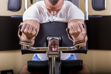 Attractive young man training in the gym