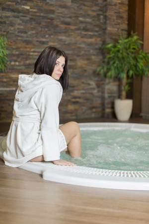 Young woman relaxing in the hot tubの写真素材