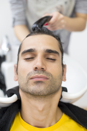 Young man at hairdresserの写真素材