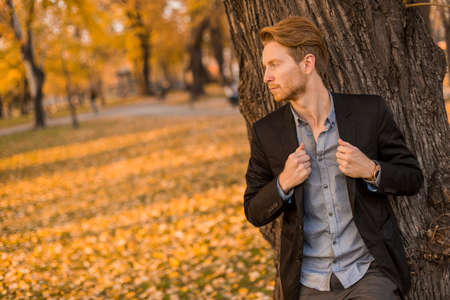 Young man in the autumn parkの写真素材
